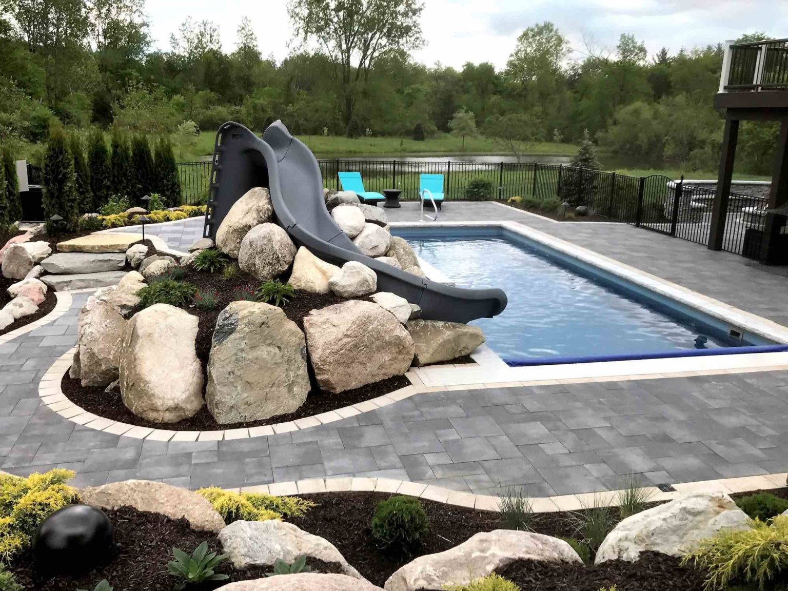 Pool and cascade spa michigan custom pools and spas Swim spas in southeast michigan Outdoor living space with custom pool and spa pool with slide