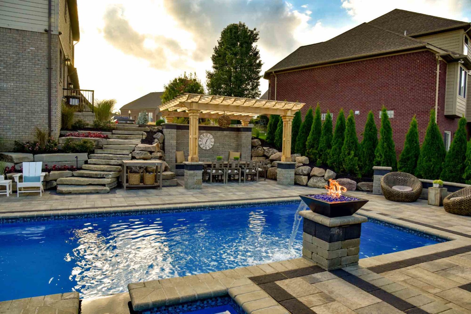Arborvitae privacy trees  fiberglass pool designers in Shelby Twp, Mi landscape design project in Shelby Township cascade fiberglass swimming pool design with a raised spillover spa  custom cedar pergola  shade structure for outdoor living  fiberglass pool and spa design Pergola Designs Outdoor Pergolas Pergola Ideas Custom Pergola Construction Pergola Kits Pergola Installation Michigan Landscape Design Landscape Design Services in Michigan Professional Landscape Design Michigan Michigan Landscape Architects Best Landscape Designers in Michigan