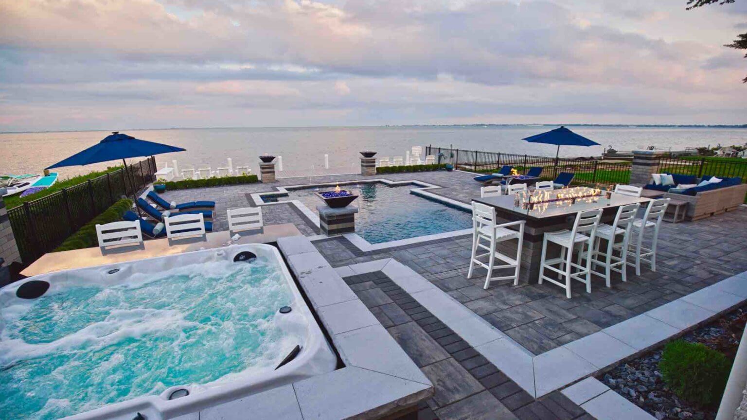 lakeside pool with adjacent hot tub and lakefront patio