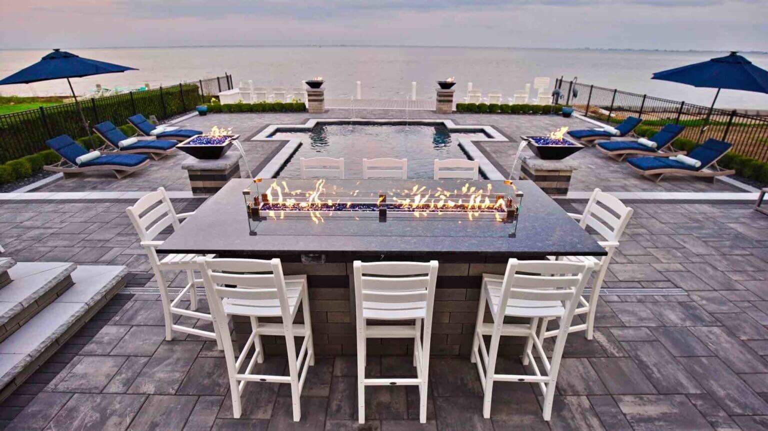 dining table next to lakeside pool