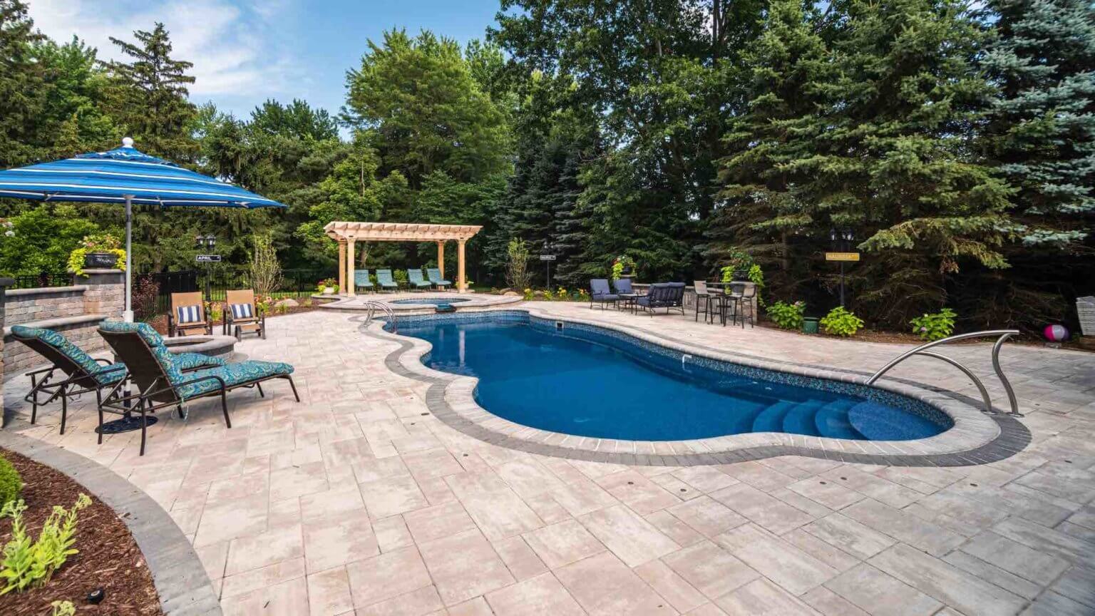 backyard patio and pool with deck tables and chairs