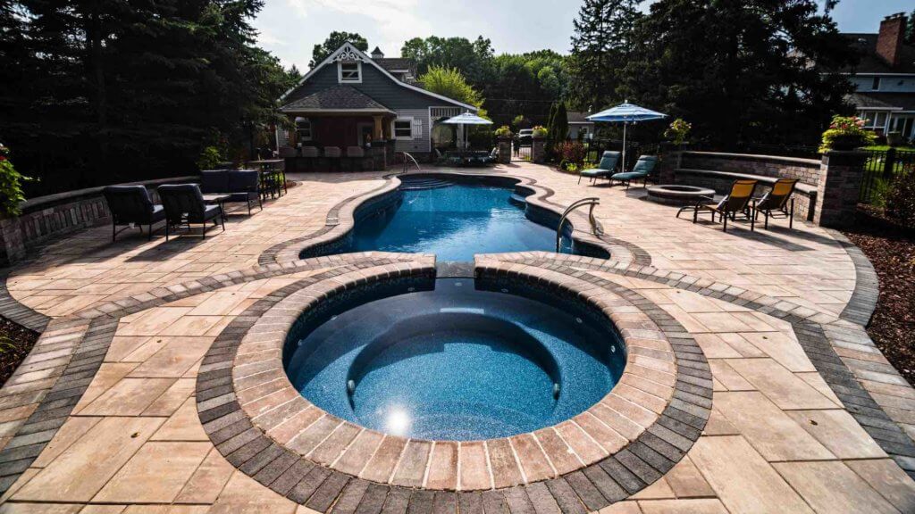hot tub and pool with patio and firepit outdoor luxury space Custom inground pools Backyard pool ideas detroit Michigan Pavers Paver Installation Michigan Paver Contractors in Michigan Best Pavers in Michigan Michigan Patio Pavers Driveway Pavers Michigan Walkway Pavers Michigan pool and spa design Metro Detroit Metro Detroit pool and spa experts Custom pool design Metro Detroit Spa installation in Metro Detroit