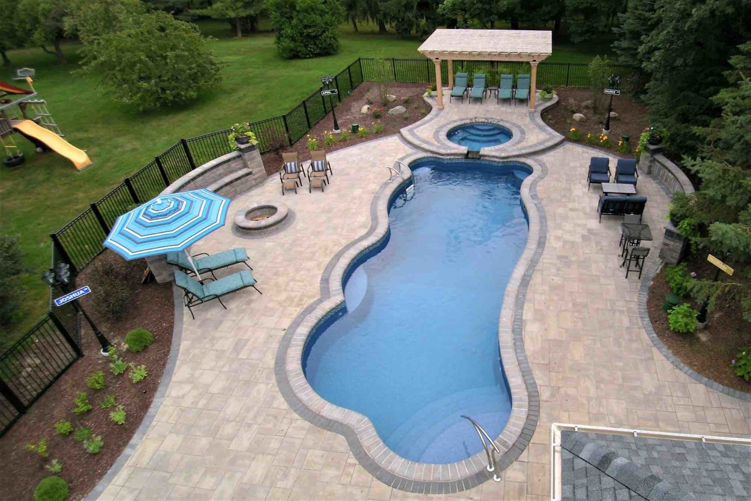 aerial view of pool, hot tube, fire pit and poolside lounge