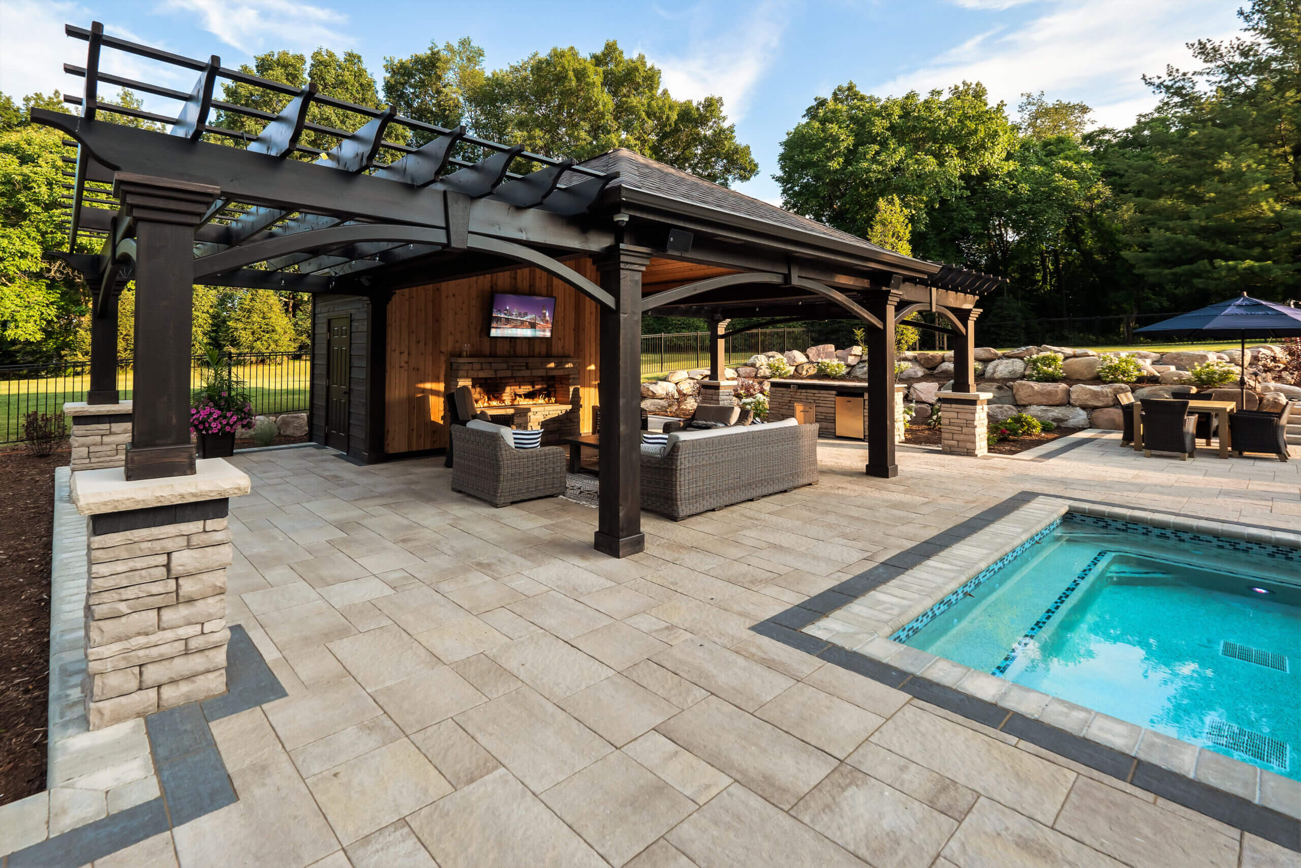 gunite pools, patio pavers, concrete paving, inground pools, pool and spa, fire bowls, patio covers in michigan, patio ideas, pool inspo, gazebos in michigan, cabanas in Michigan, backyard design, backyard landscape design, fire bowls, pool fountains, concrete builders, unilock, outdoor fireplaces in michigan, jacuzzi, outdoor hot tubs, pergola, gazebo, backyard ideas, patio design near me