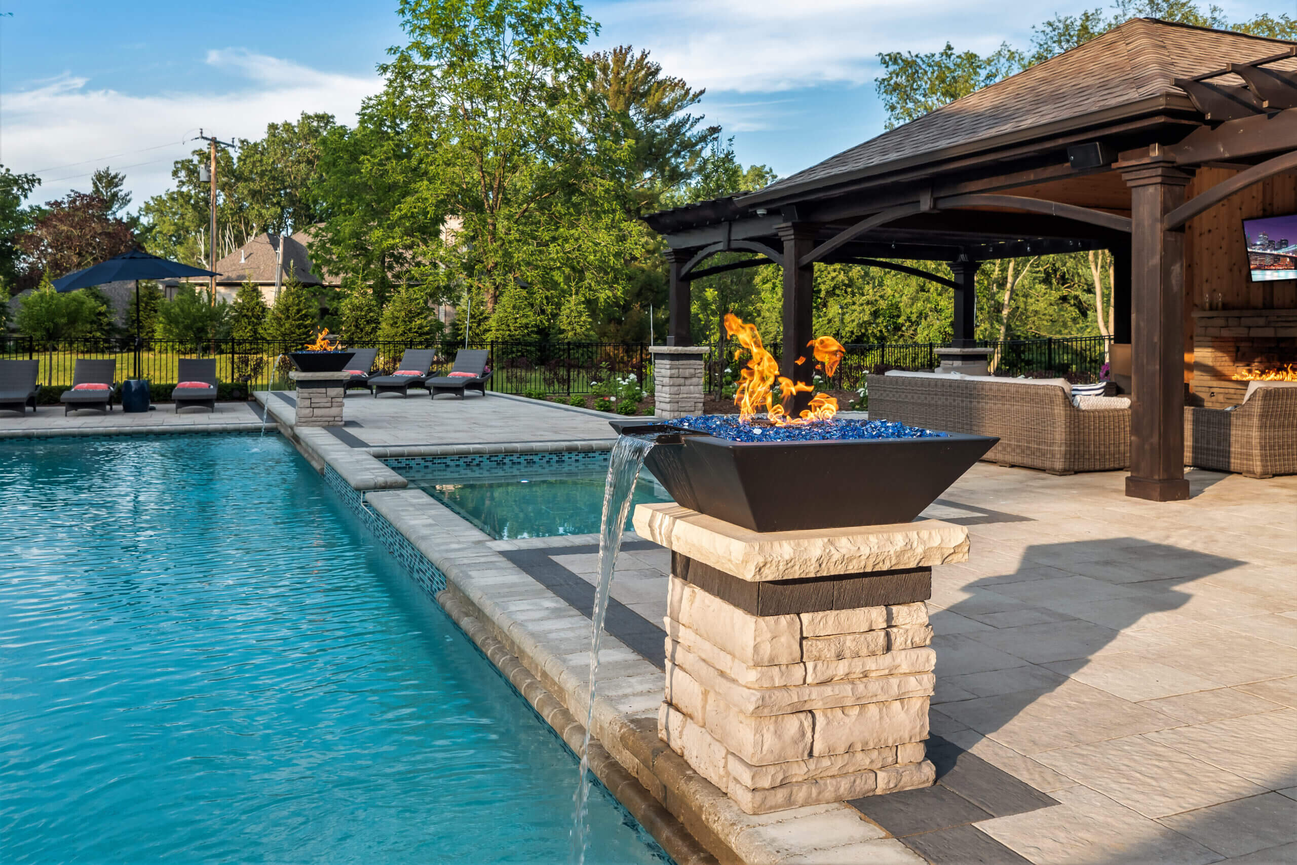 gunite pools, patio pavers, concrete paving, inground pools, pool and spa, fire bowls, patio covers in michigan, patio ideas, pool inspo, gazebos in michigan, cabanas in Michigan, backyard design, backyard landscape design, fire bowls, pool fountains, concrete builders, unilock