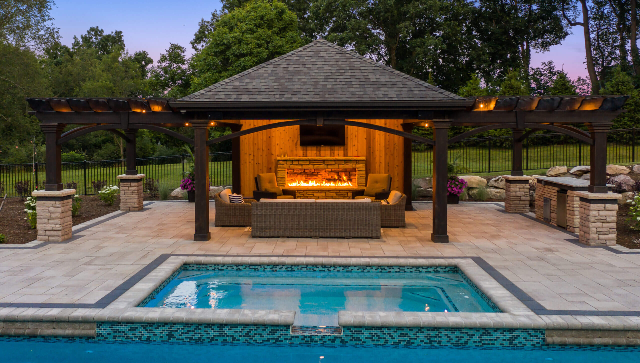gunite pools, patio pavers, concrete paving, inground pools, pool and spa, fire bowls, patio covers in michigan, patio ideas, pool inspo, gazebos in michigan, cabanas in Michigan, backyard design, backyard landscape design, fire bowls, pool fountains, concrete builders, unilock, outdoor fireplaces in michigan, jacuzzi, outdoor hot tubs